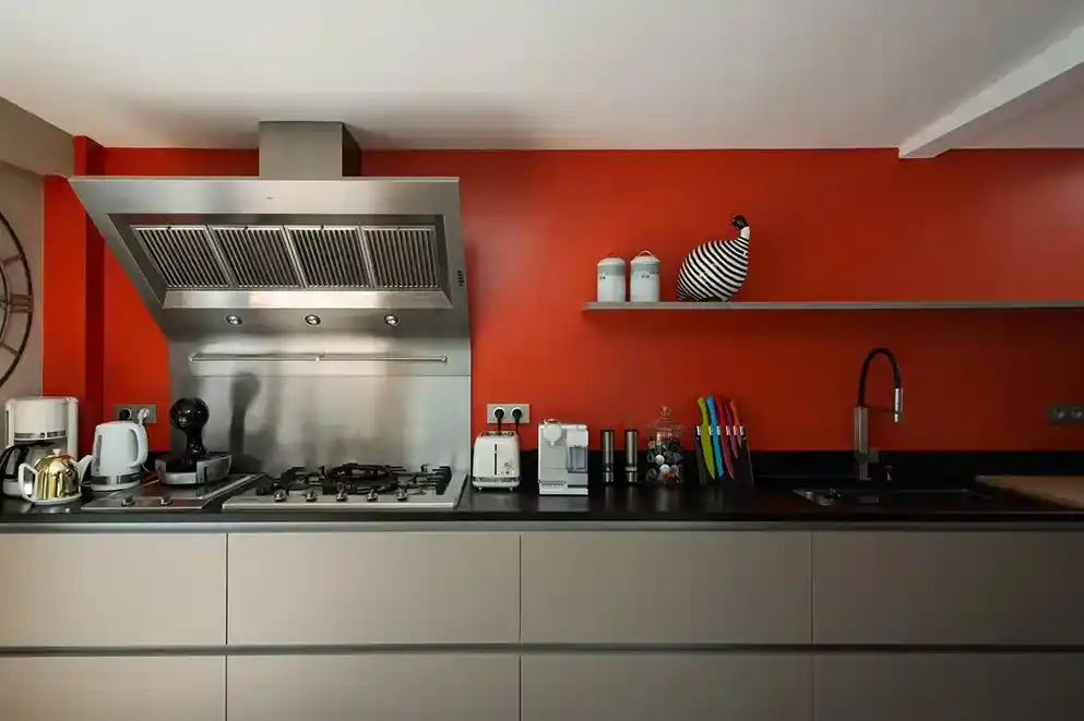 villa-chanteclair-cuisine-mur-rouge-deauville Cuisine moderne de la Villa Chanteclair à Deauville avec mur rouge et équipements contemporains